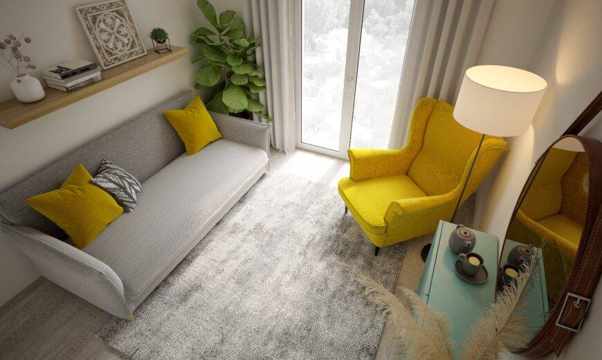 Above angle of a small living room with grey and yellow decor.