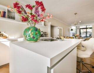 A low shot of a kitchen island with a smooth white countertop.