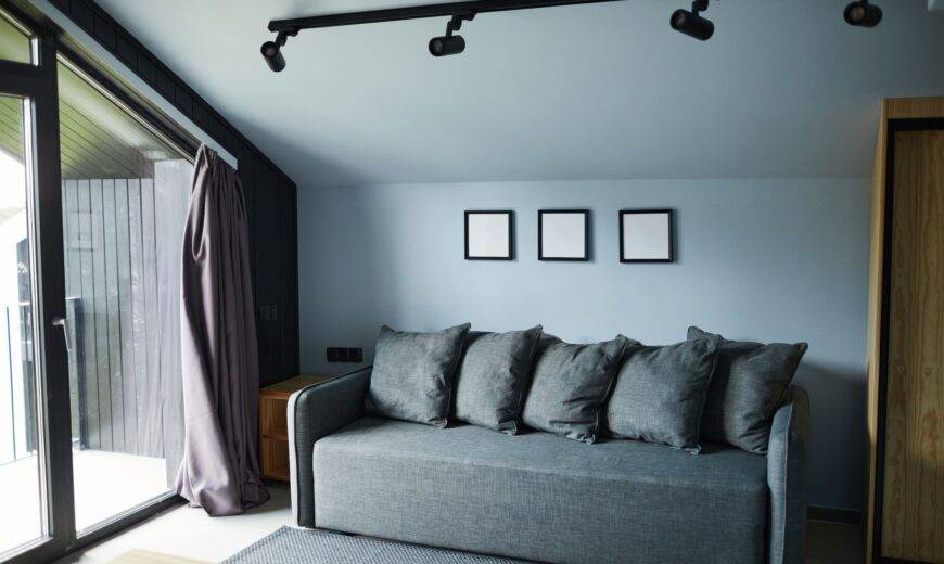A living room next to large glass doors that are pouring light in.