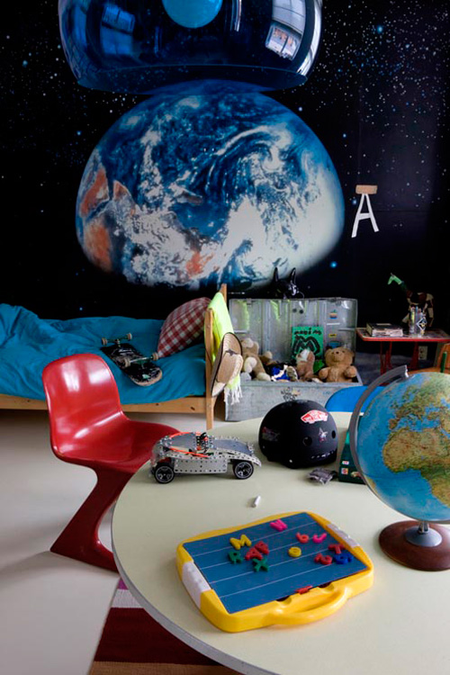 Space children's room with educational props flanked by a painting of Earth.