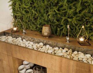 A two person bathroom sink full of stones.