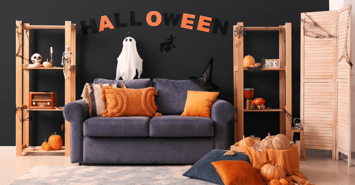 A dark living room with orange halloween decoration.